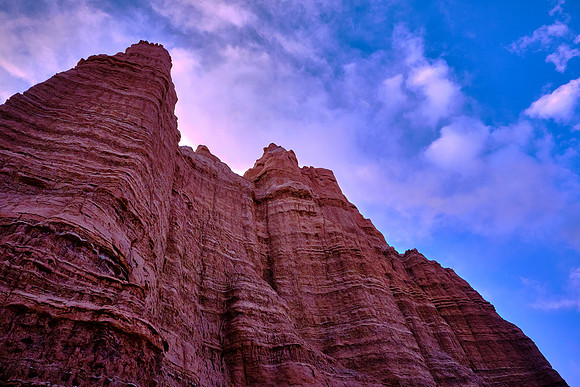 Temple of the Sun, UT.  The Entrada Sandstone crumbles easily to sand that  is rapidly removed by water; therefore, talus slopes do not form and the cliffs tend to rise sheer from their base.