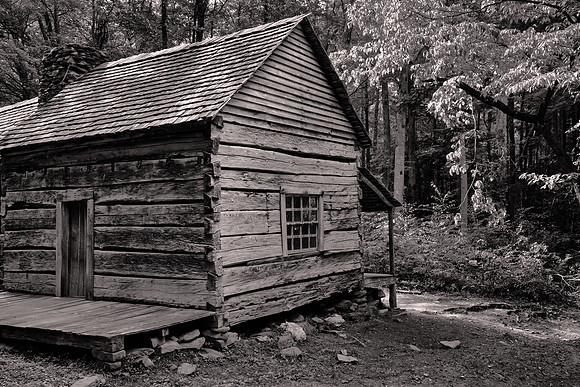 The cabin is a “saddlebag” house. Two structures are connected by a common chimney.