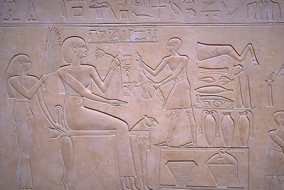 This ancient Egyptian bas-relief depicts the giving of food and drink to an Egyptian goddess for the afterlife.