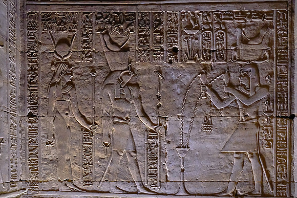 Gift of wine is presented to god Horus and the goddess Hathor.