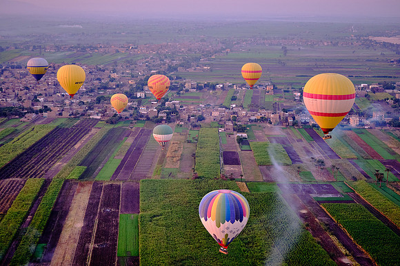 Early morning balloon ascension over the plains of Luxor.