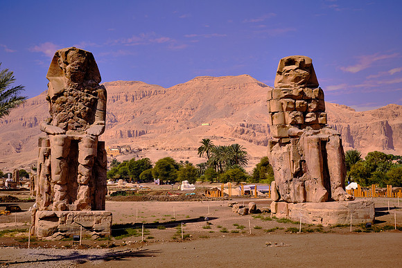 The Colossi of Memnon are two stone statues of Pharaoh Amenhotep III that stand at the front of the his Mortuary Temple.