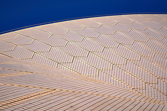 Its precast concrete "sails" are clad in over 1 million glossy white and matte cream self-cleaning ceramic tiles.
