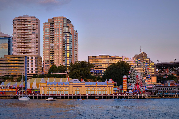 Luna Park is a historic amusement park in Sydney with Milsons Point residential high-rises behind.