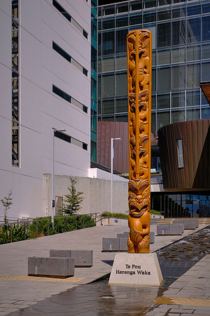 The title of this carved wooden post translates to "the post that ties the canoes together" --- a gathering place.