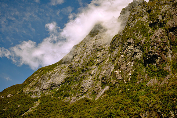 Post-glacial rock avalanches and landslides filled basins, while heavy rainfall preserves thick vegetation.