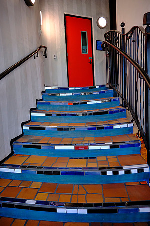 The building is a Hundertwasser‑designed structure with bright mosaics and undulating forms typical of his style.