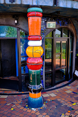 Hundertwasser buildings are known for their vibrant colors and mosaic columns as seen here.