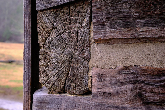 The house was built of hand-cut logs, and the inside faces of the logs were chopped smooth.