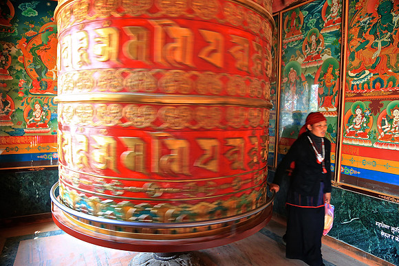 Giant prayer wheel in motion, Boudhanath Stupa, Kathmandu, Nepal