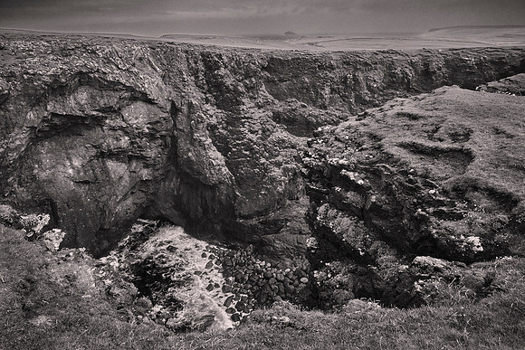 To the north of the geo is a sea cave that may be the largest natural chamber in Britain (shown here).