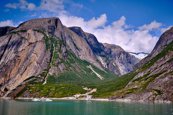 Then extensive geologic excavation caused by moving ice reshapes the landscape.