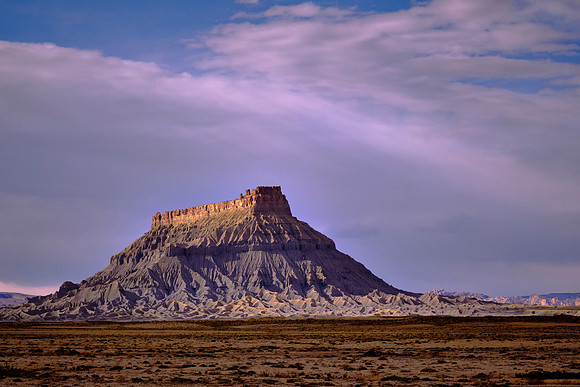 Factory Butte, UT, at sunset.  The butte was named by early settlers who thought its outline resembled a huge woolen mill factory in Provo.