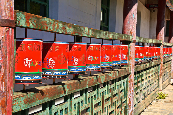 Prayer wheels  line the sides of the center. Believers spin the wheels clockwise to follow the sun while rotating the syllables of the mantra in the direction they should be read.