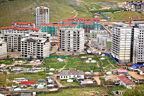 New, affordable-condo construction interspersed with nomadic gers.