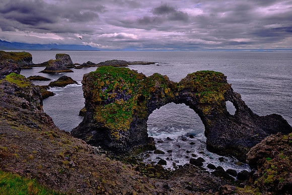 The beach at Arnarstapi has an eroded circular stone arch, called Gatklettur.