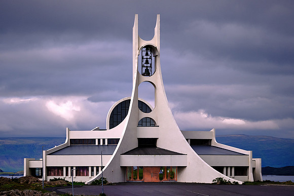 The futuristic church has a sweeping bell tower that looks like a whale vertebra.