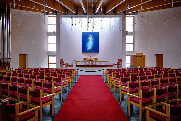 There are hundreds of suspended lights and a Madonna and child floating in the night sky.