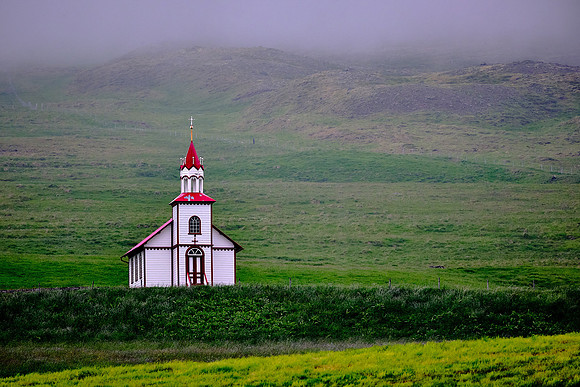 Small red and white church east of Sauoarkrokur.