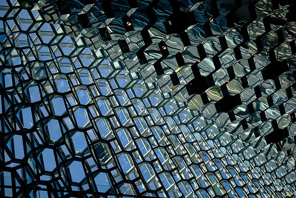 The building features a glass facade inspired by the basalt landscape of Iceland.