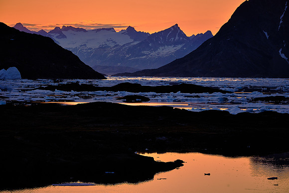 Sunset (10:30 PM) over Kulusuk looking north to pack ice in Torsuut Strait.