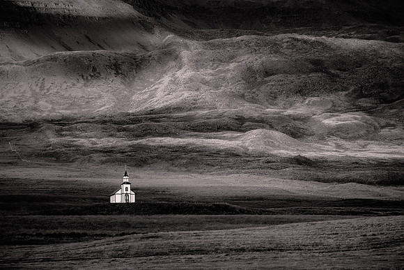 2023 June 29.  Rural Icelandic church under sun and shade.