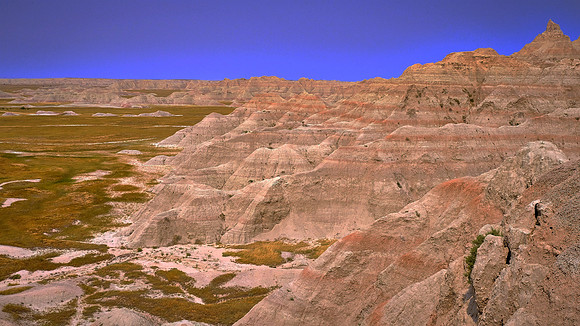 Ongoing erosional forces carve sedimentary rock formations in Badlands National Park, SD