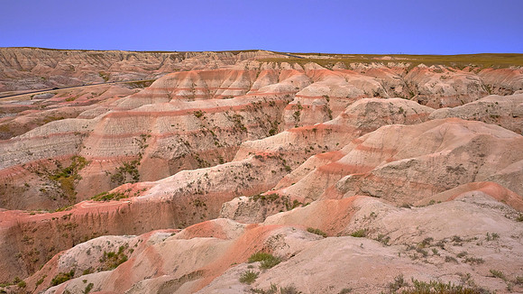Ongoing erosional forces carve sedimentary rock formations in Badlands National Park, SD