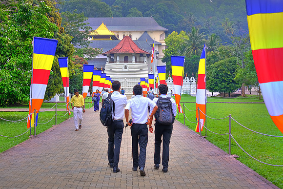 Pilgrims arrive and depart from The Temple of the Sacred Tooth Relic, Kandy, Sri Lanka