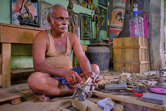 Lost-wax bronze casting artist at work.