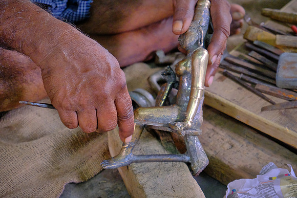Lost-wax bronze casting artist at work.