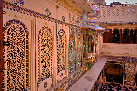 The interiors of the palace complex with its balconies, towers and cupolas exhibit delicate mirror-work, marble-work, murals, wall paintings, silver-work, inlay-work and leftover of colored glass.