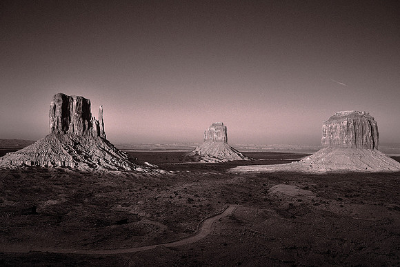 Monument Valley, UT, West Mitten Butte, East Mitten Butte, and Merrick Butte at sunset.
