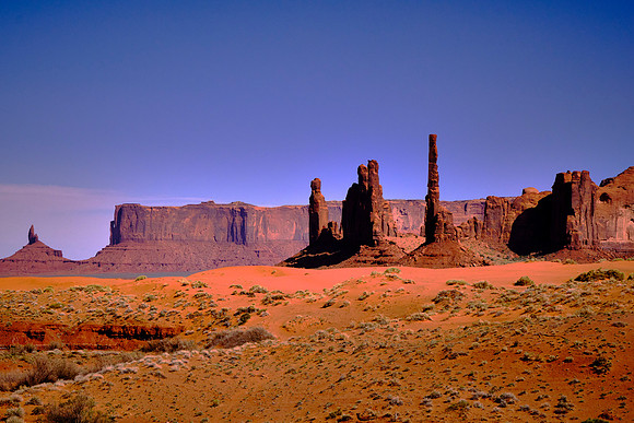 Monument Valley, UT.  The Totem Pole and Thunderbird Mesa.  The valley floor is largely siltstone of the Cutler Group  deposited by the meandering rivers that carved the valley.
