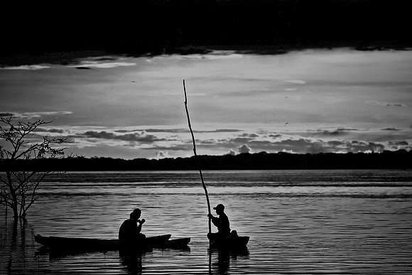 Fisherman at sunset on the Amazon River