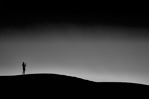 Astrophotographer at sunset over White Sands National Monument, New Mexico