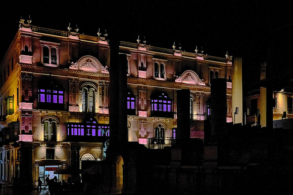 The wooden balconies (in purple light) are vestiges of British architecture.