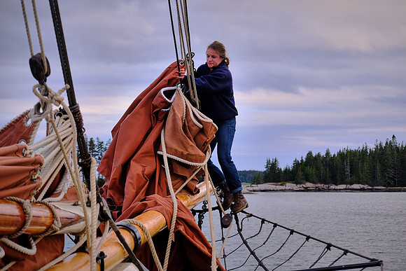 First Mate Kaila furls the topsail, Windjammer Angelique, Camden, Maine