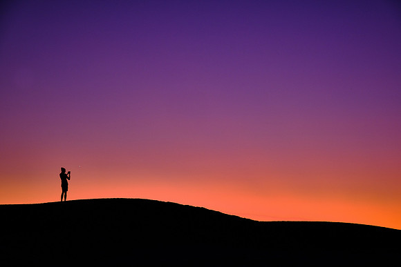 Astrophotographer at sunset over White Sands National Monument, New Mexico