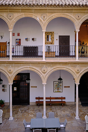 The central patio has a twin-tiered arcade supported by slender marble Doric columns.