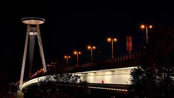 The UFO bridge has a total length of 1,413 ft.  Its steel construction is suspended from steel cables and connected to two pillars.