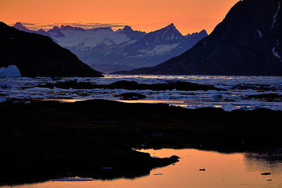 Sunset (10:30 PM) over Kulusuk looking north to pack ice in Torsuut Strait.