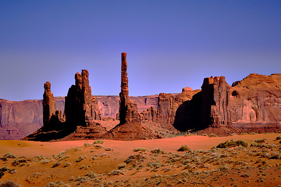 Monument Valley, UT, the Totem Pole and Thunderbird Mesa.  Deserts at the end of the Permian Period, 260 million years ago, formed the Wingate Sandstones that make up the buttes, totems, and mesas.