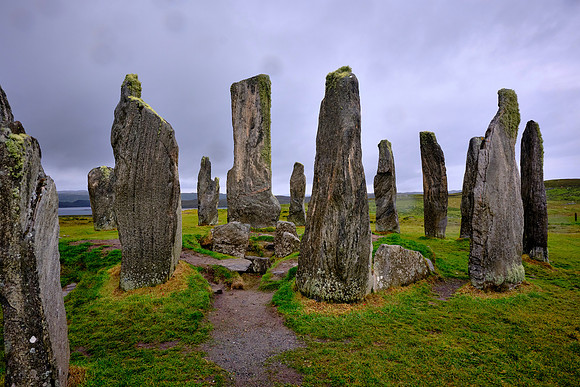 Calanais Standing Stones are in a cruciform pattern with a central stone circle, located on the Isle of Lewis.