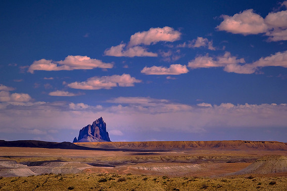 Shiprock, NM, looking south at midday. Shiprock is a volcanic plug rising 1,583 feet above the high-desert and 7,177 feet above sea level.