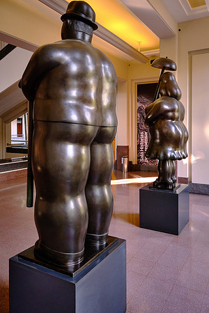 Botero's signature style depicts people and figures in large, exaggerated volume.