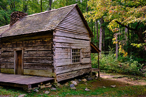 The cabin is a “saddlebag” house. Two structures are connected by a common chimney.