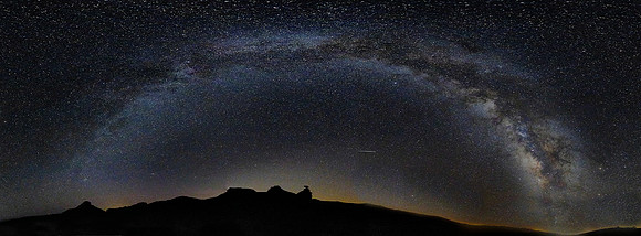The Milky Way arch over Mexican Hat, UT.   See the Mexican Hat in the lower center of the image.   Meteorites were a common site as in this image.