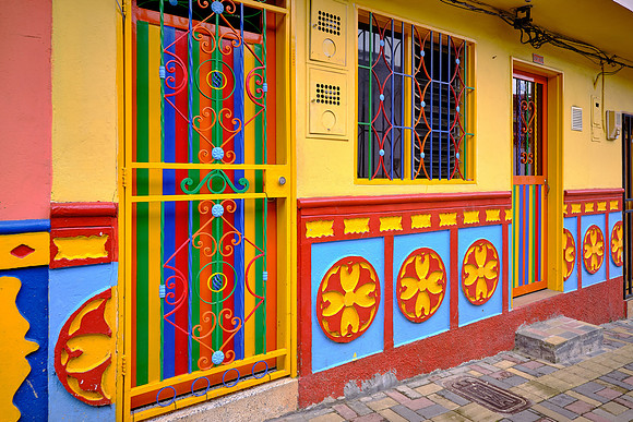Each building has tiles along the façade's lower walls in bright colors and 3-dimensional  images.
