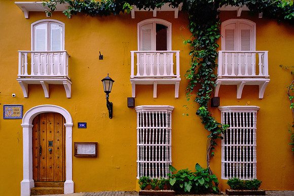 The architecture combines decorative ironwork with Spanish Baroque elements and local materials.